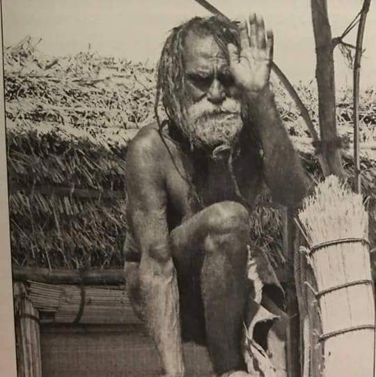 An archival photograph of Baba on his raised wooden platform